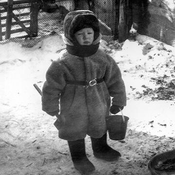 Andrew, dressed warmly in a coat, holding a toy shovel and bucket, snow, Bada Station